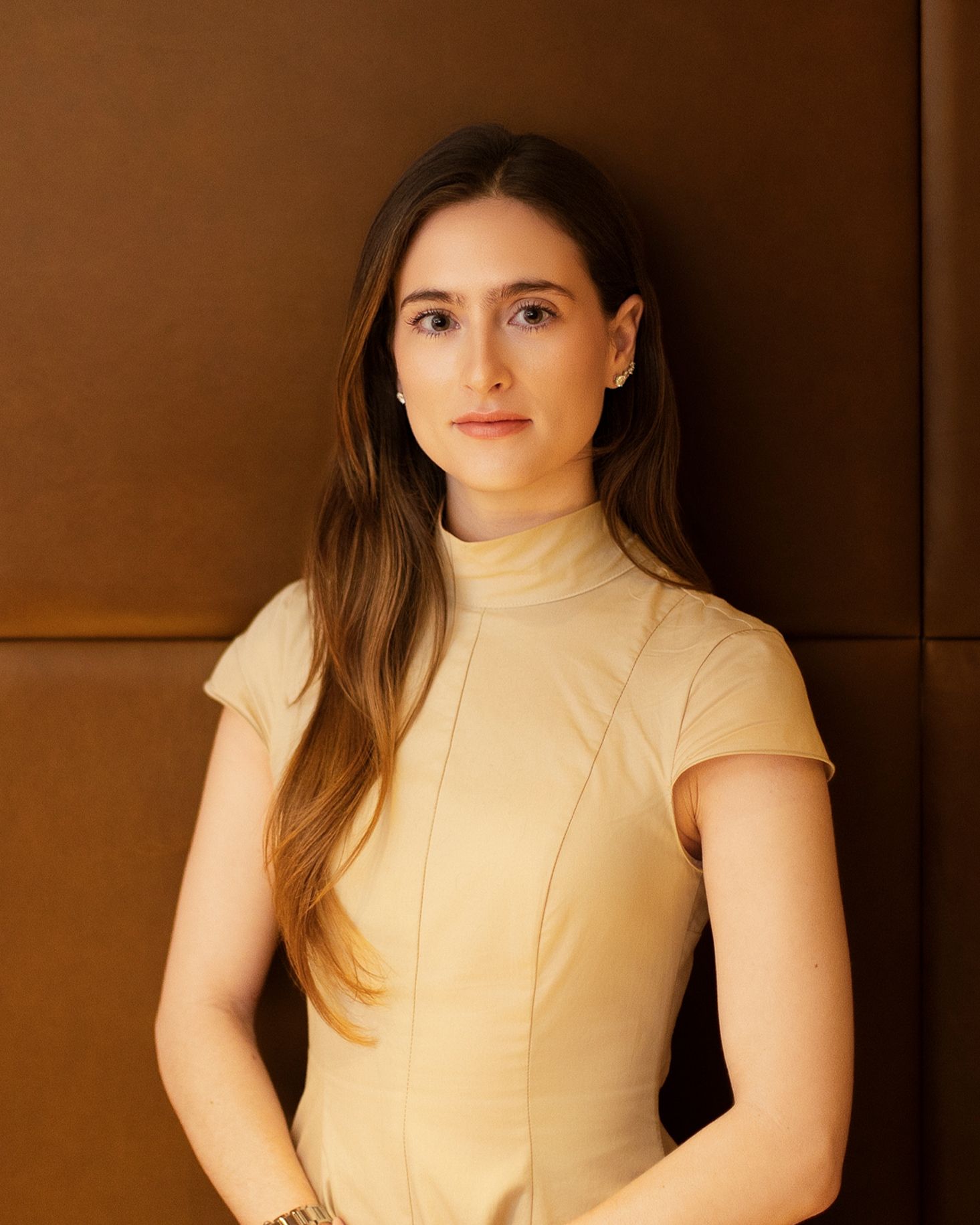 Isabella Martinez Headshot Wearing A Cream Dress